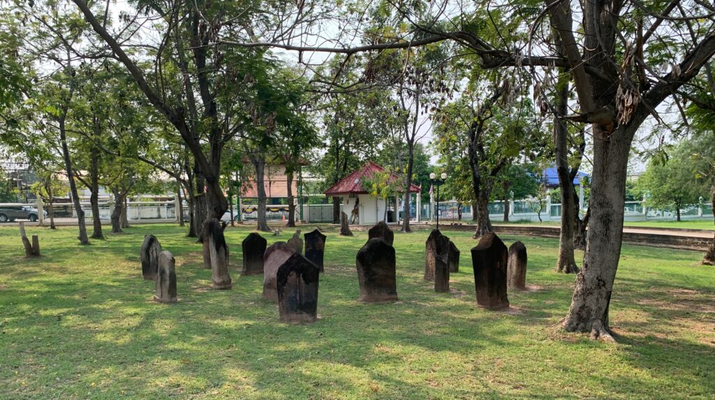 a cemetery with many headstones in a park