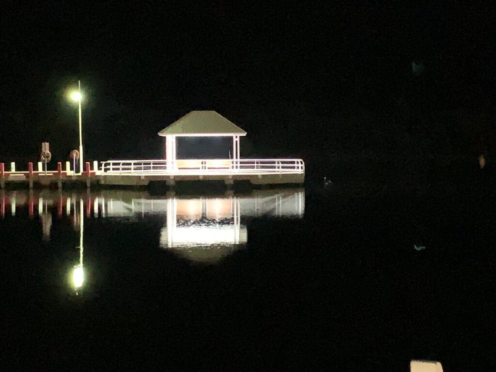 a gazebo on a dock at night