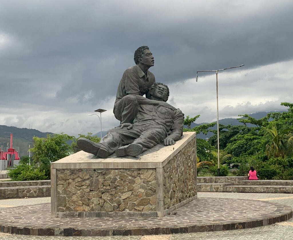 a statue of a man sitting on a man's lap