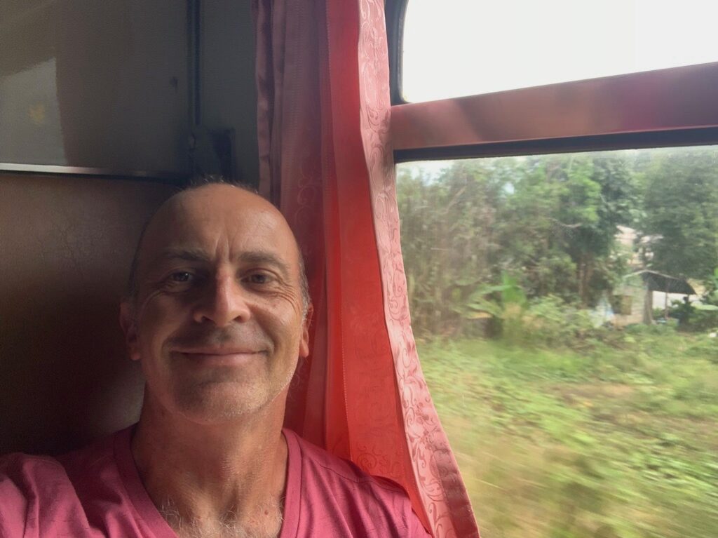 a man smiling in a train
