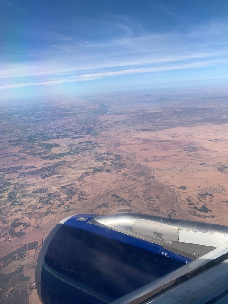 an airplane wing and a landscape