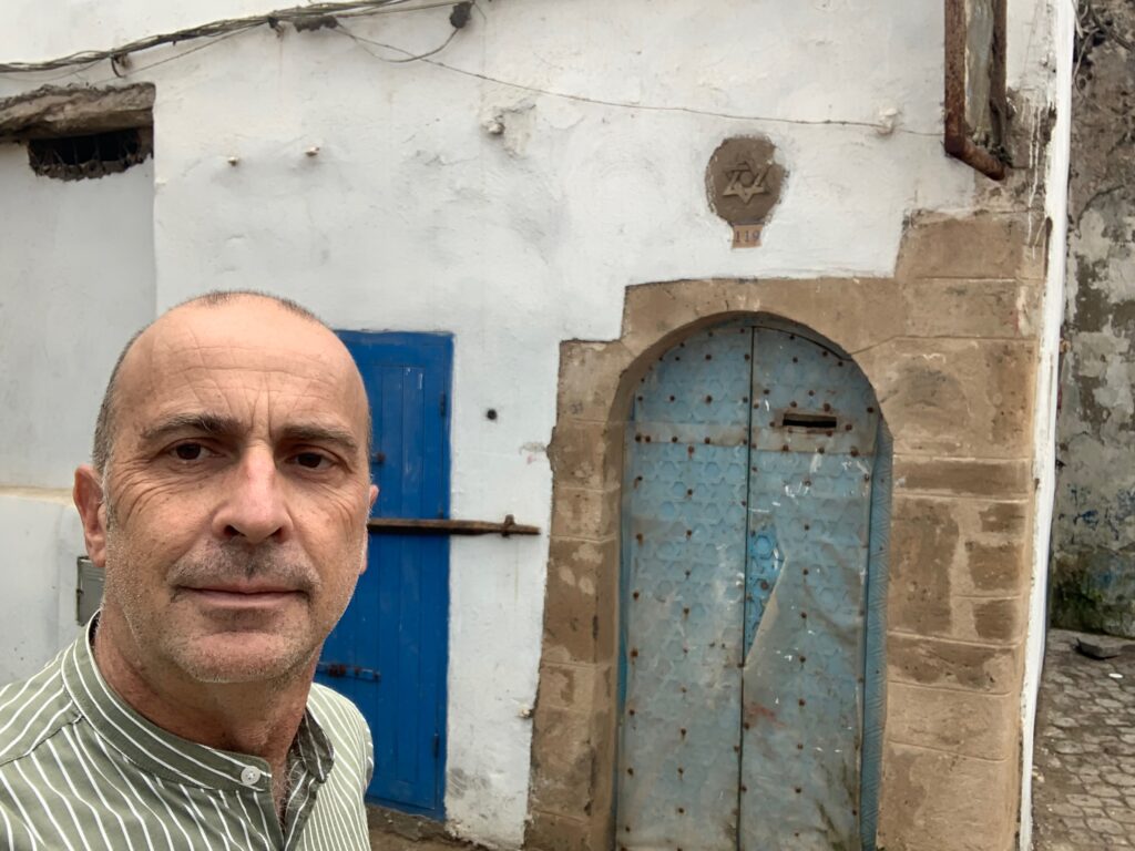 a man taking a selfie in front of a building