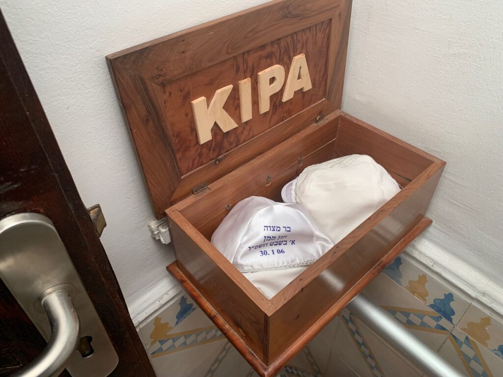 a wooden box with a hat inside