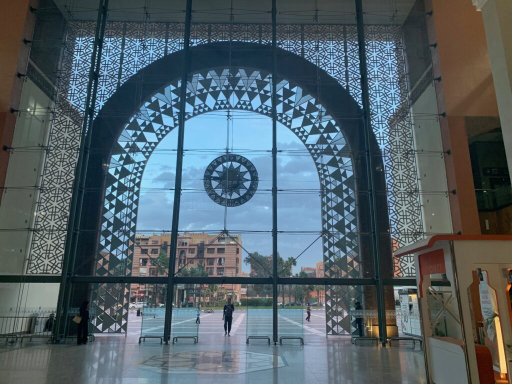 a large glass archway with a clock in it