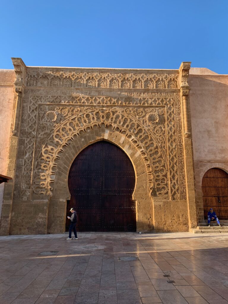 a large stone building with carved wood doors