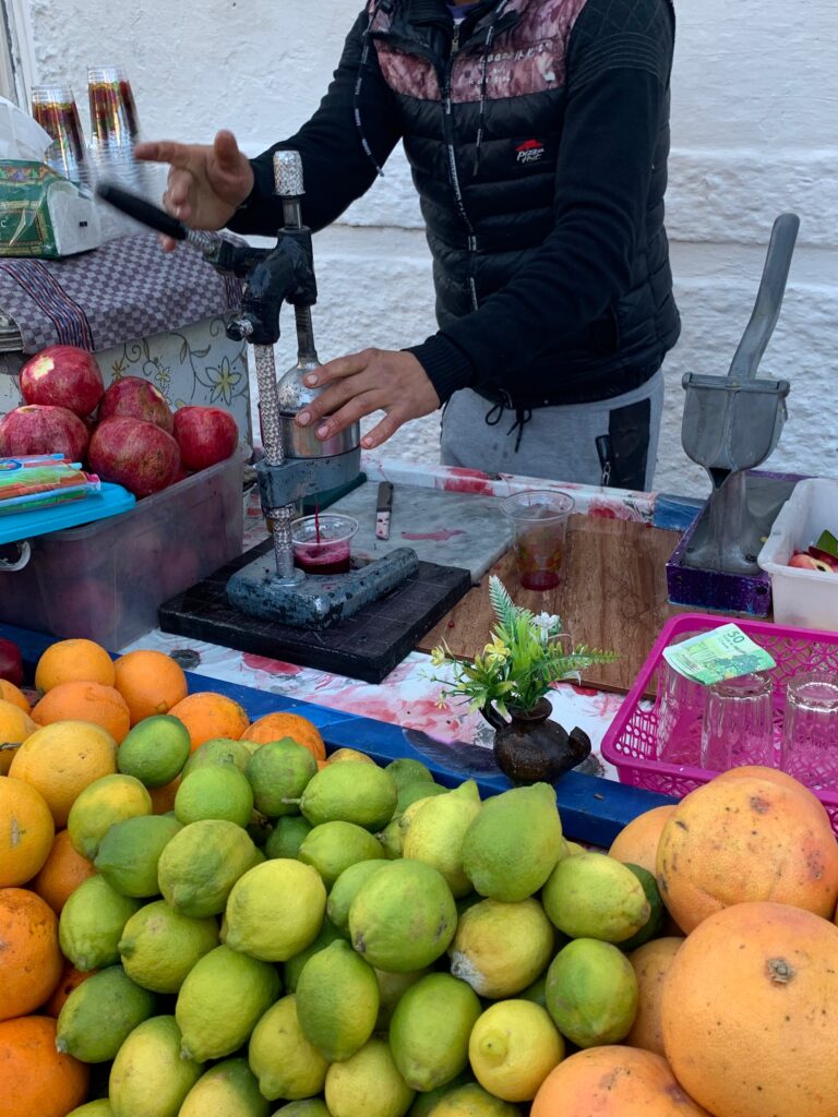 a person making juice at a fruit stand