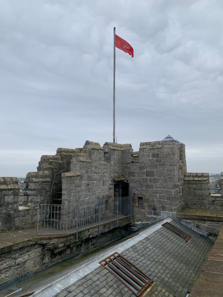 a flag on a flagpole on a stone building
