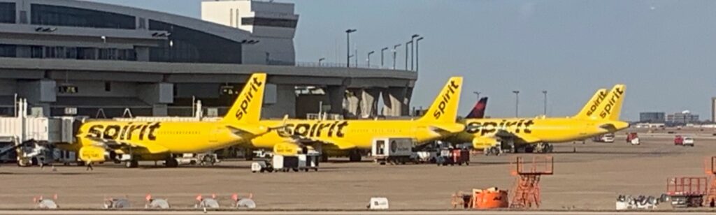 a yellow airplane parked at an airport
