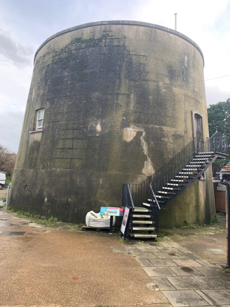 a round cement tower with a staircase