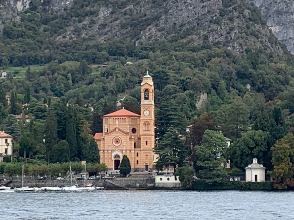 a building with a tower on the side of a lake