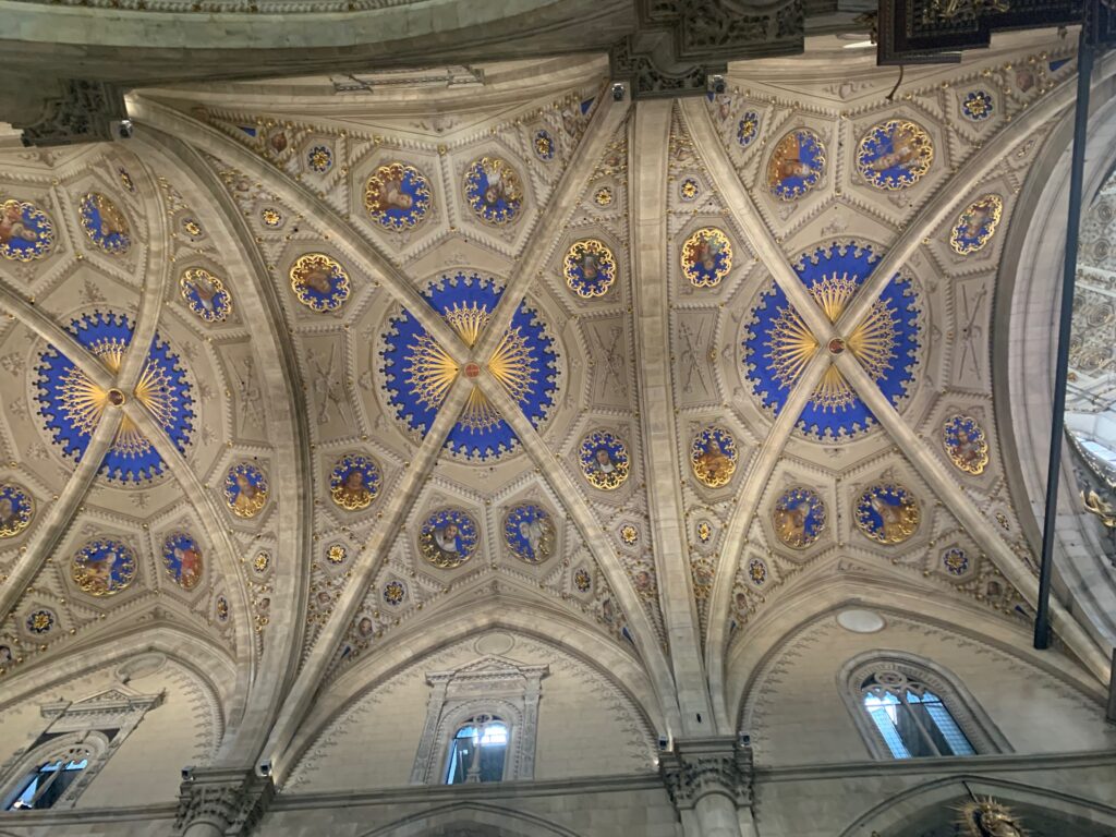 a ceiling of a building with blue and gold painted ceiling