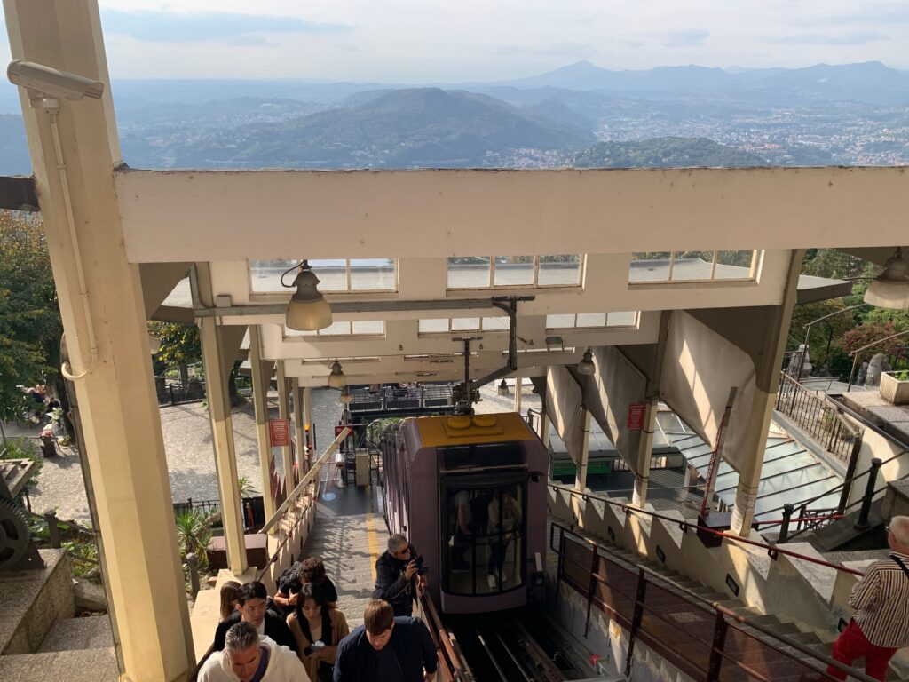 a group of people on a train going up to a hill