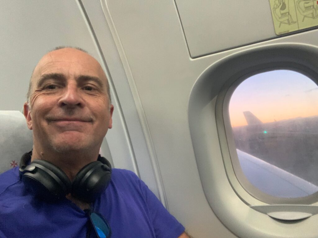 a man smiling in an airplane