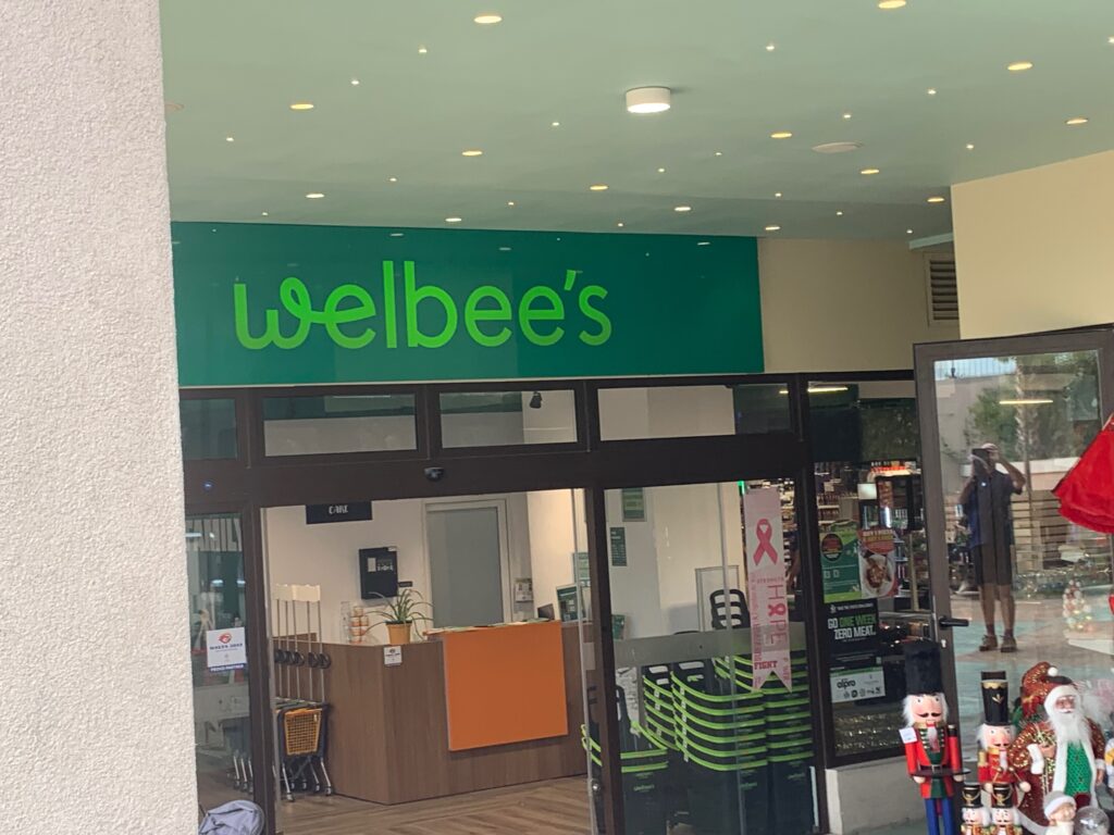 a store front with green sign