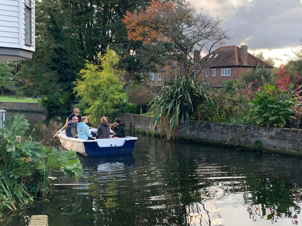 a group of people in a boat on a river