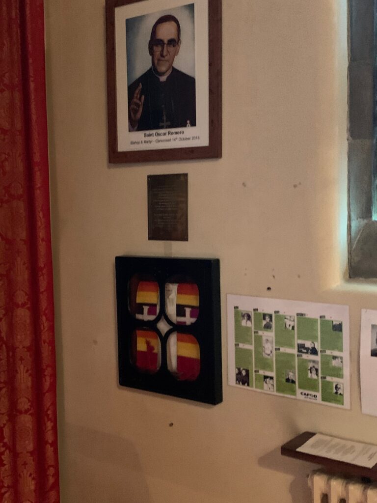 a wall with a picture of a man and a plaque