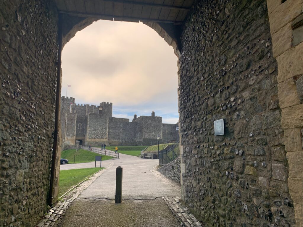 a stone archway with a castle in the background