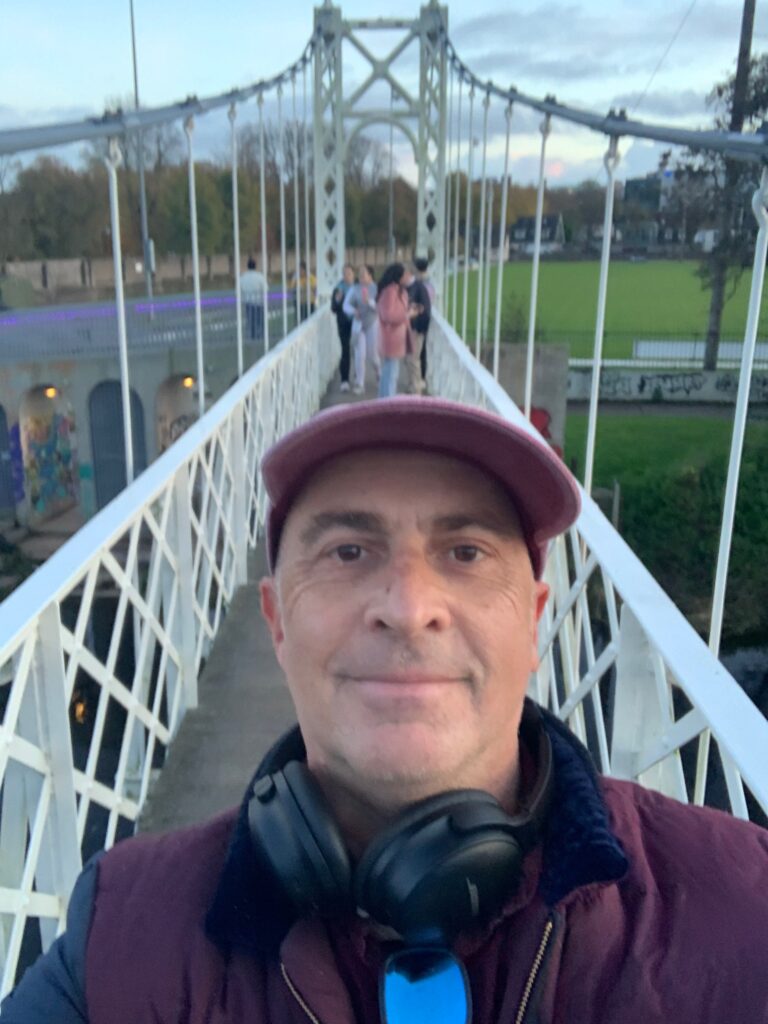 a man taking a selfie on a bridge