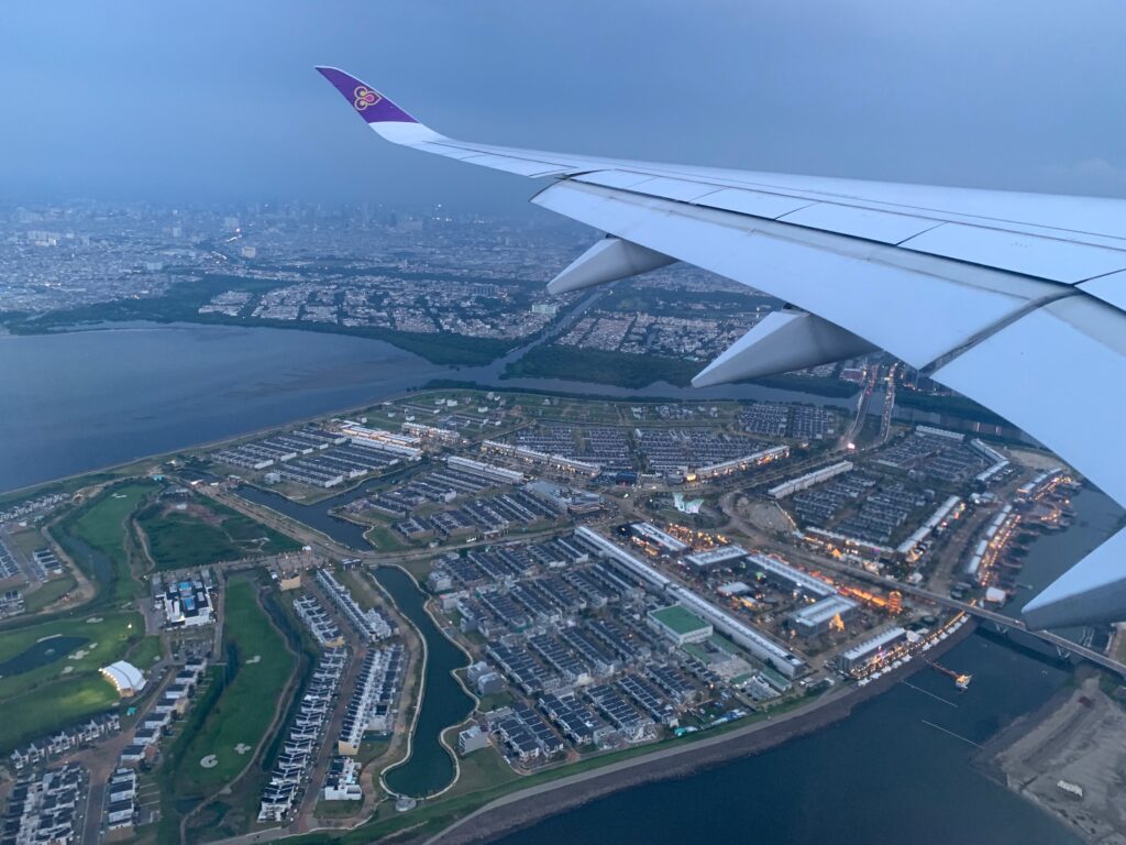 an airplane wing over a city