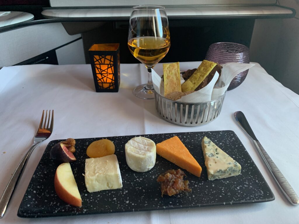 a plate of cheese and fruit on a table