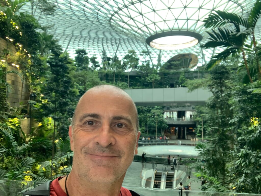 a man taking a selfie in a glass dome