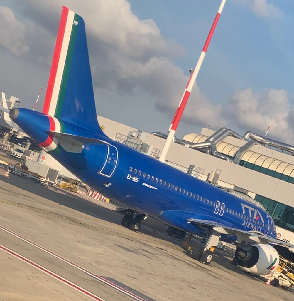 a blue airplane on the tarmac