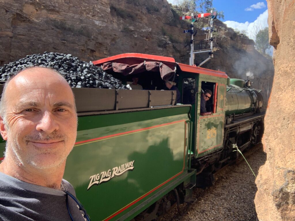 a man taking a selfie with a train