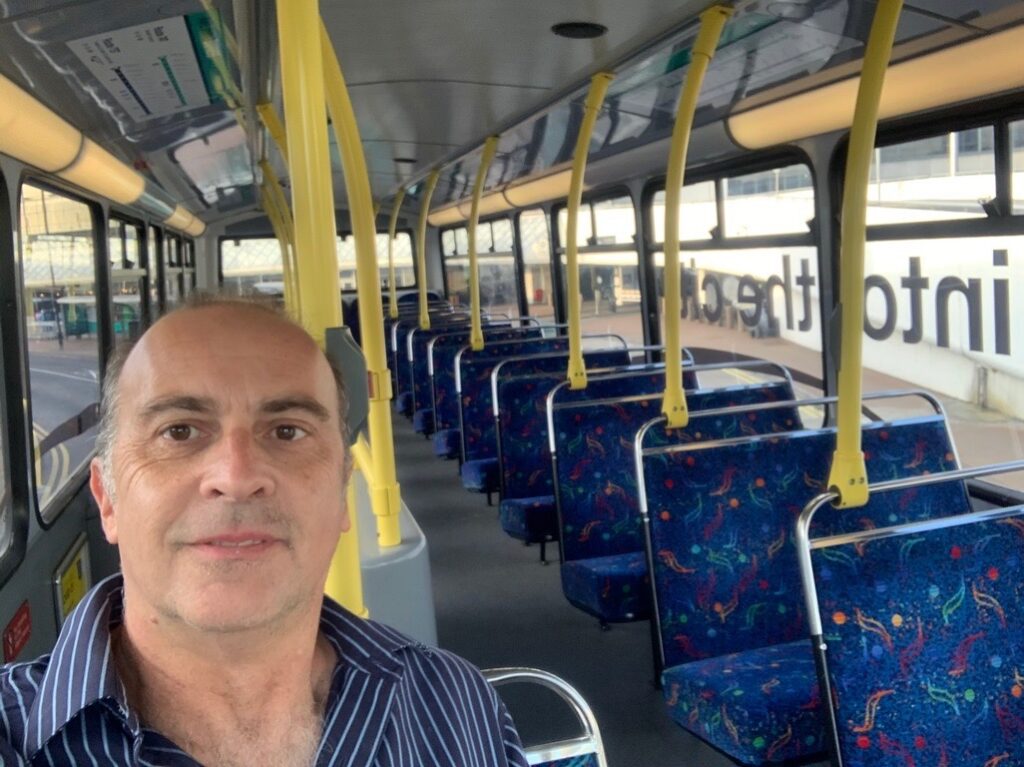 a man taking a selfie on a bus