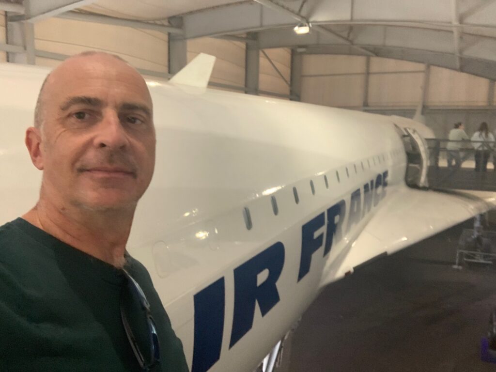 a man taking a selfie in a hangar