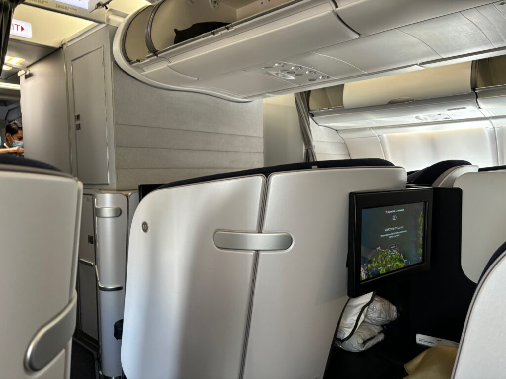 a seat and a television in an airplane