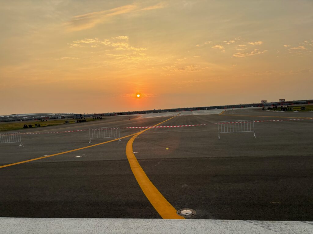 a sunset over a runway
