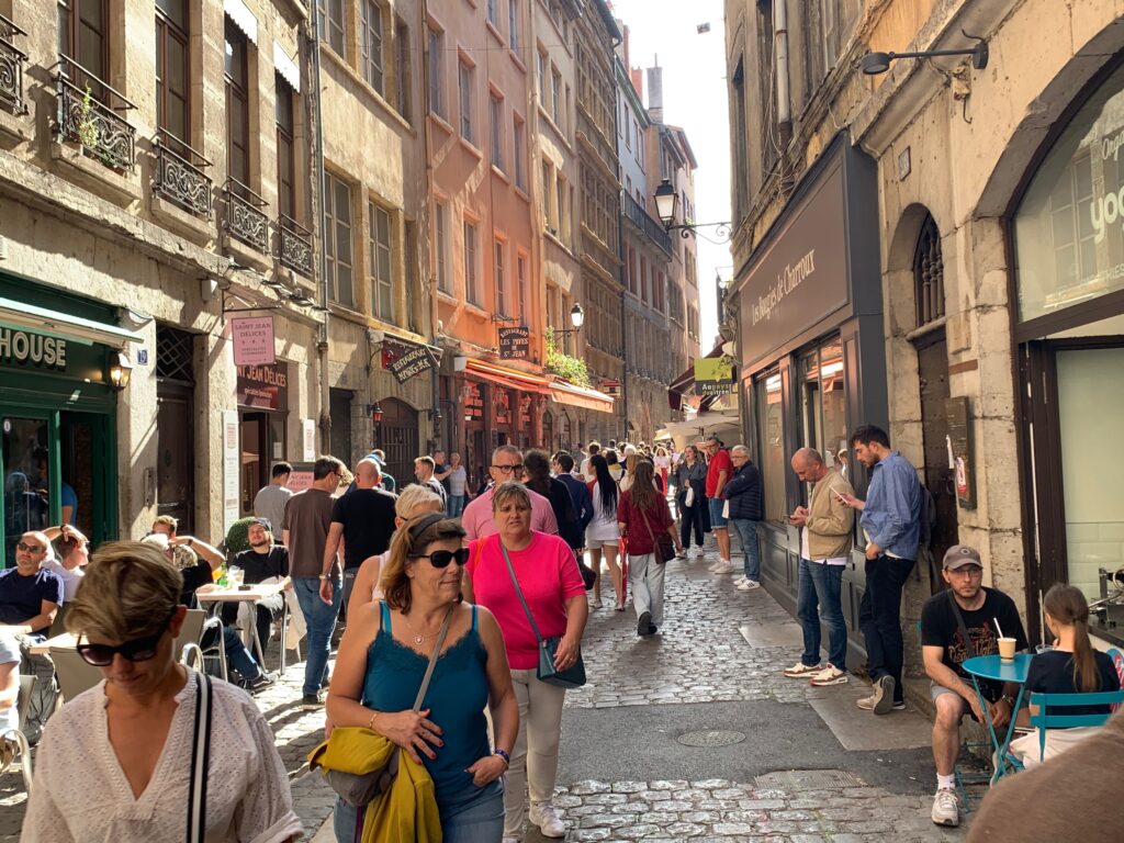 a group of people walking down a narrow street