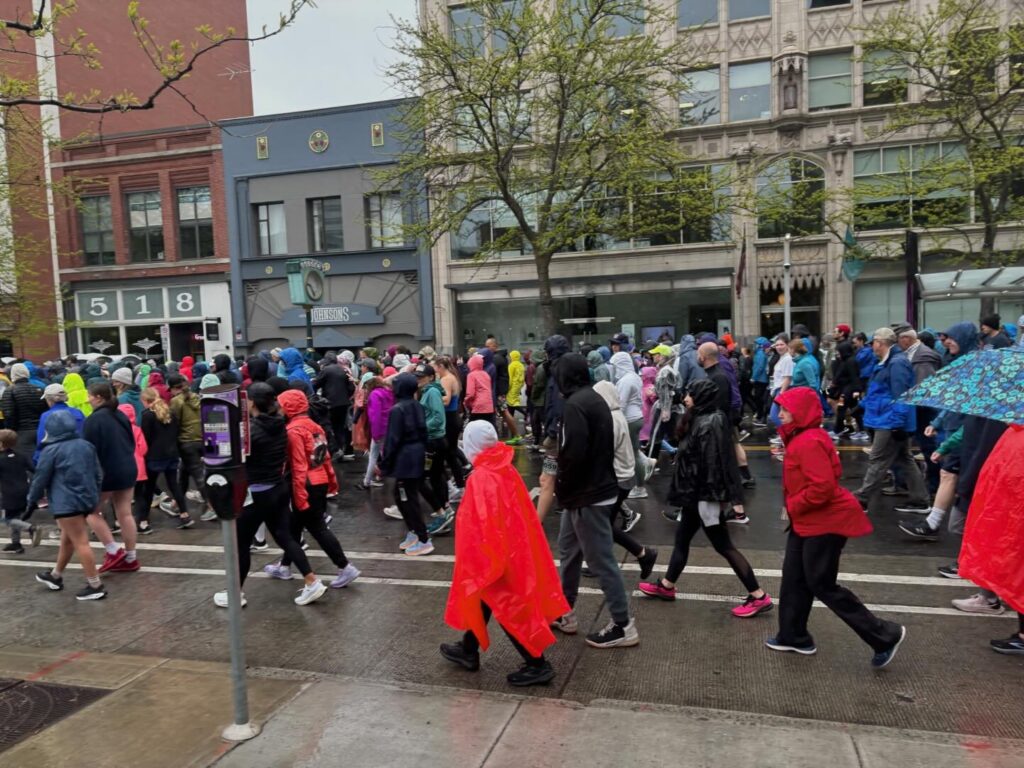 a crowd of people walking on a street