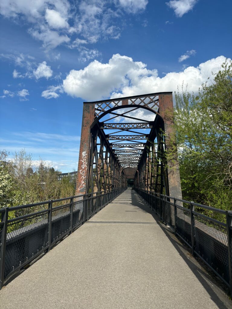 a bridge with trees and blue sky