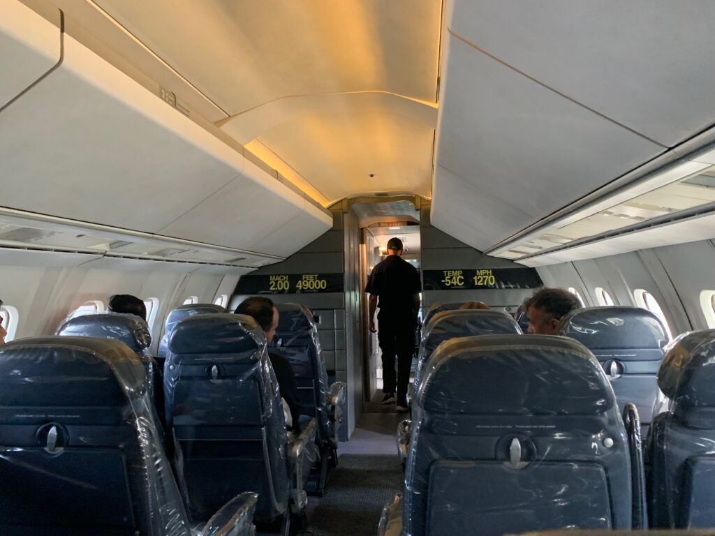 a person standing in the back of an airplane