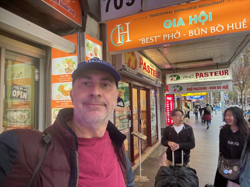 a man taking a selfie in front of a store