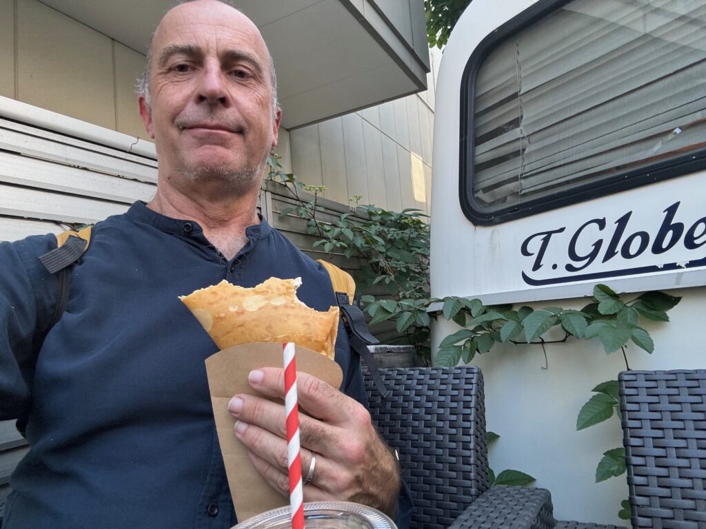 a man holding a food and a straw