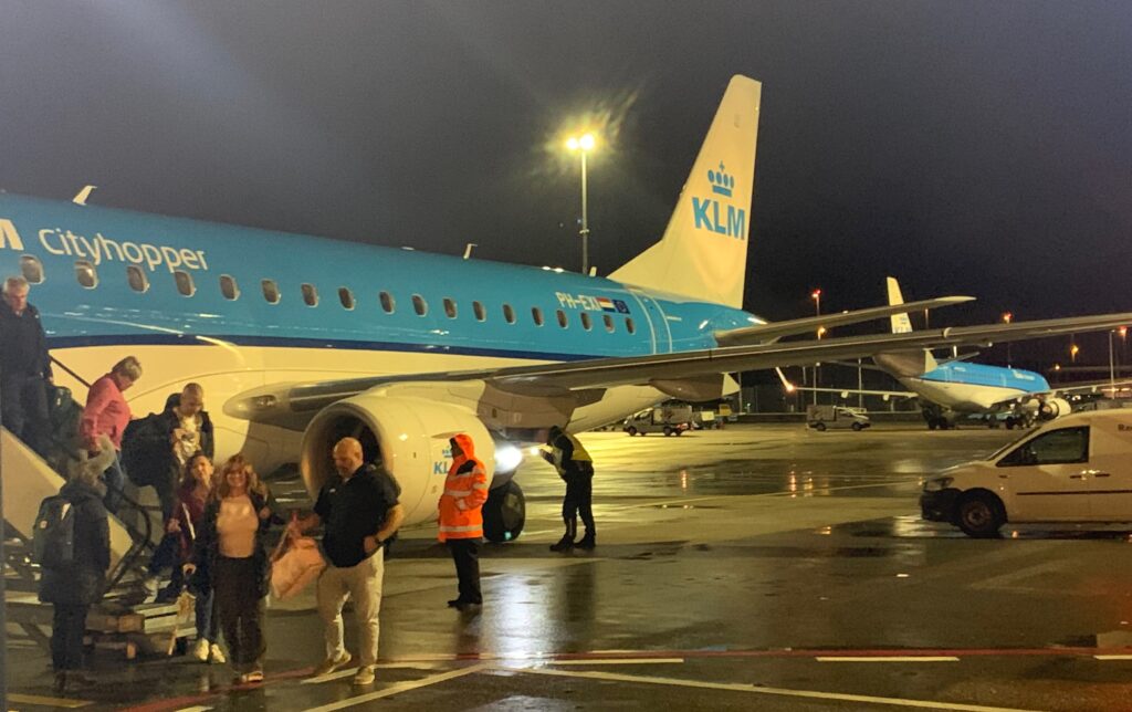 people standing next to an airplane