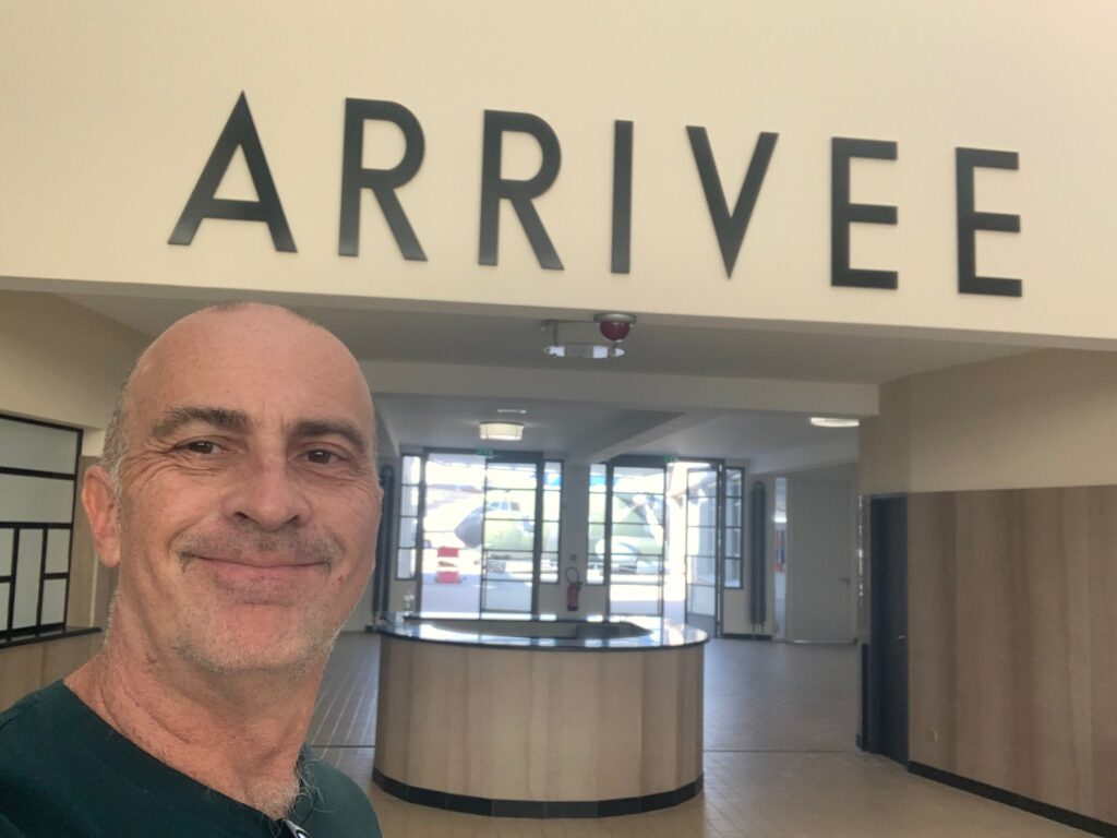 a man taking a selfie in front of a sign