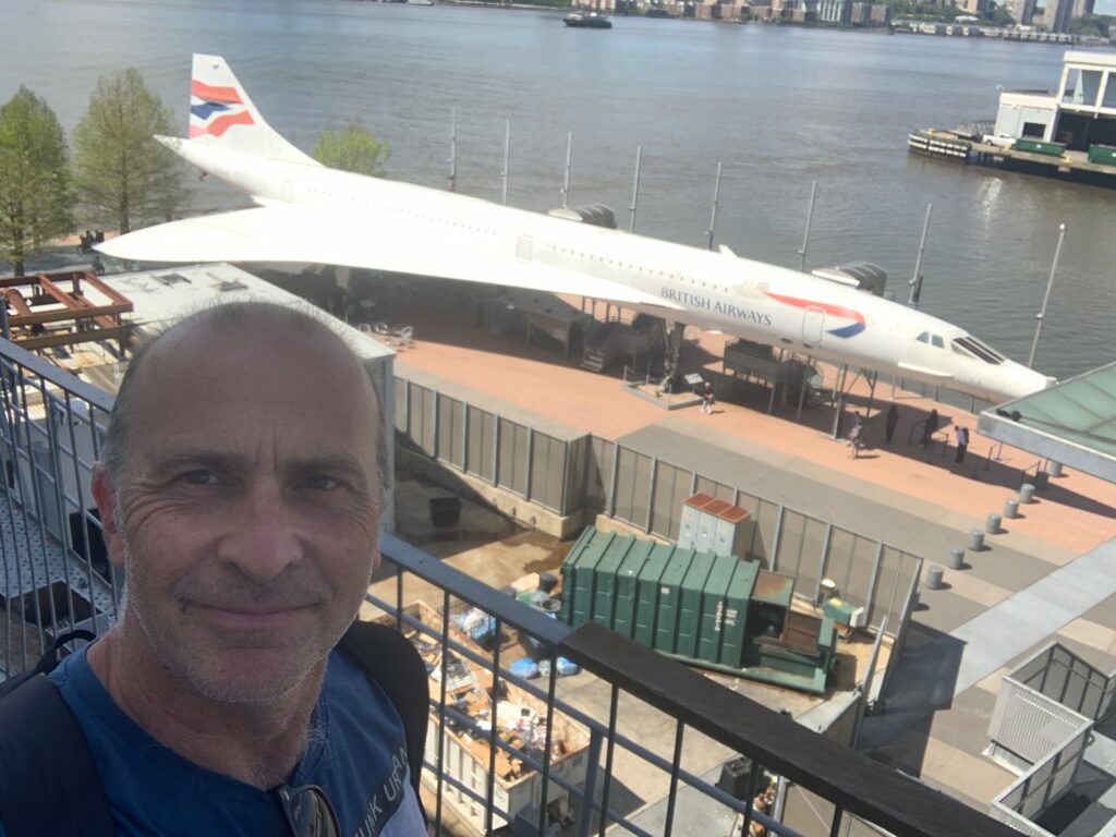 a man taking a selfie in front of a plane