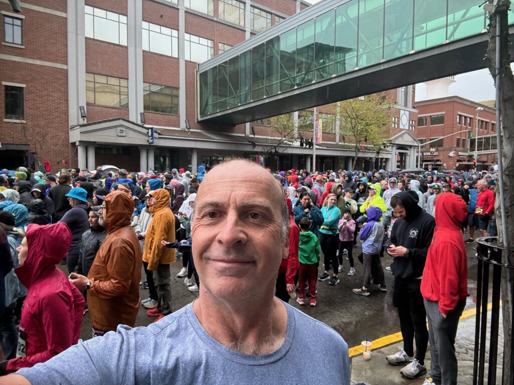 a man taking a selfie in front of a large crowd of people