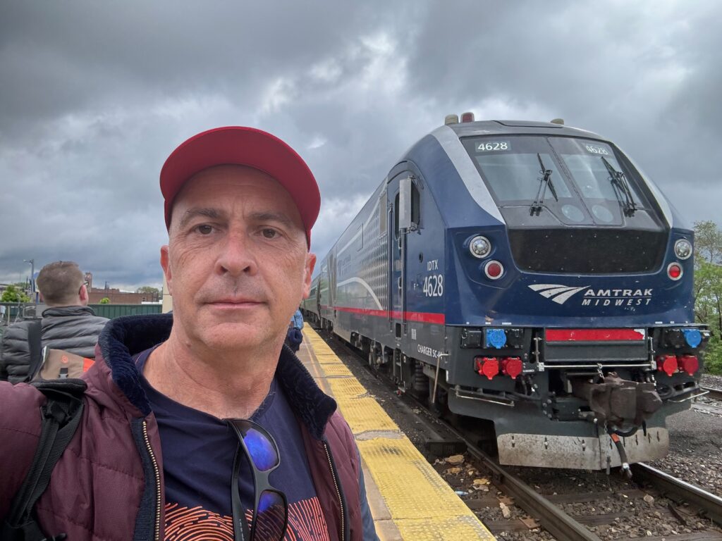 a man taking a selfie in front of a train