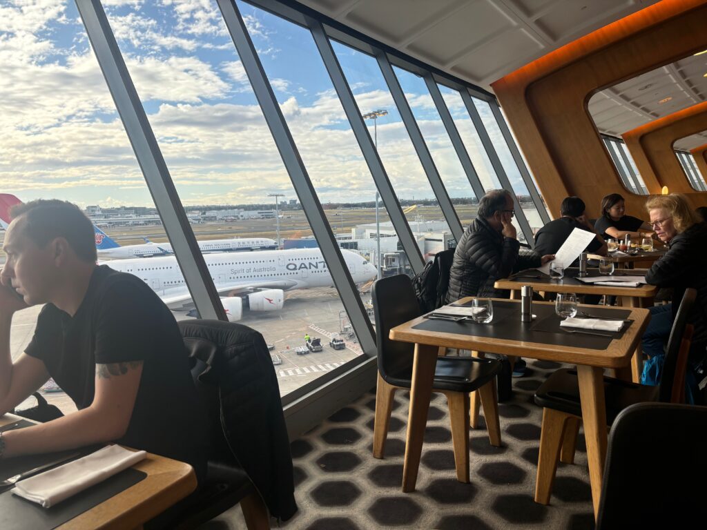 a group of people sitting at tables in a restaurant