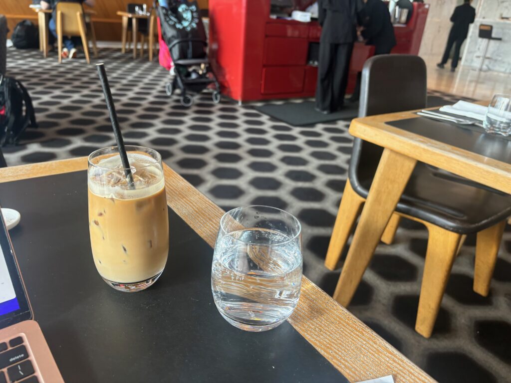 a glass of liquid and a straw on a table