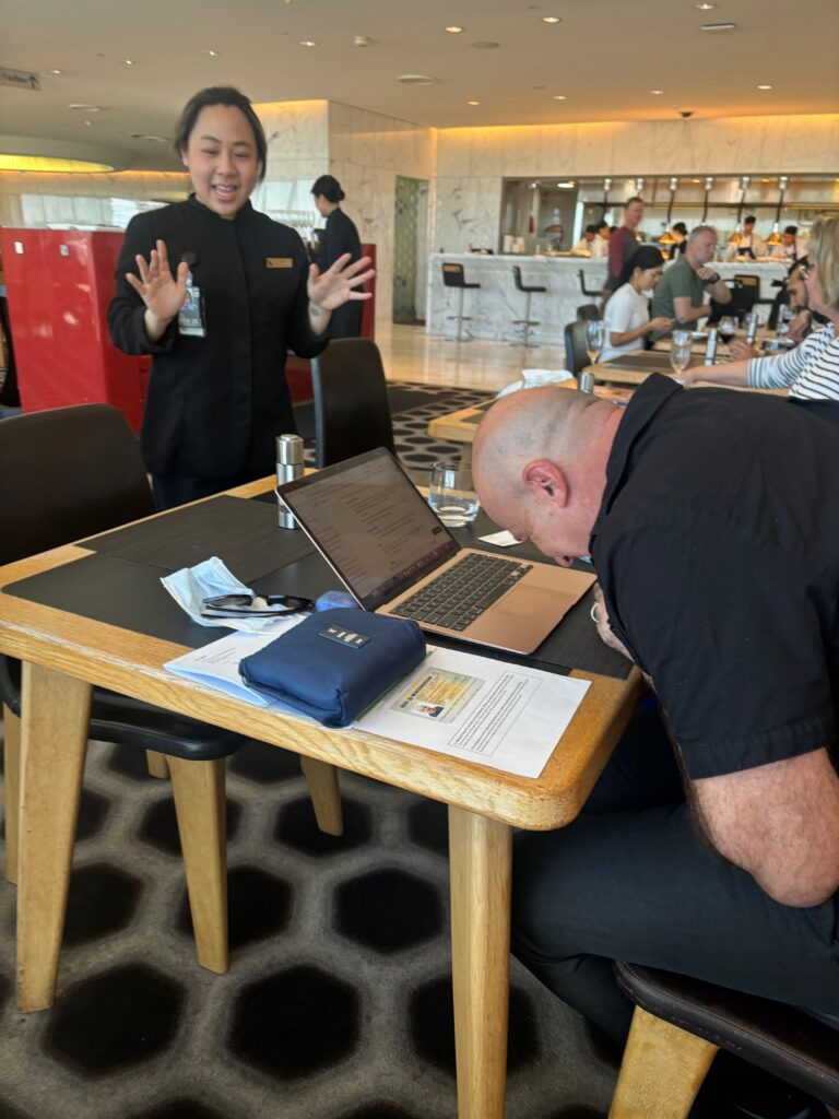 a man sitting at a table with a laptop