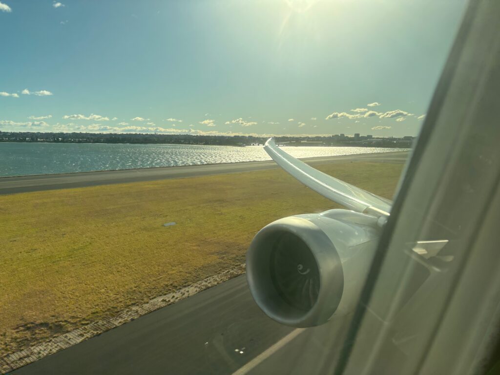 a wing of an airplane on a runway