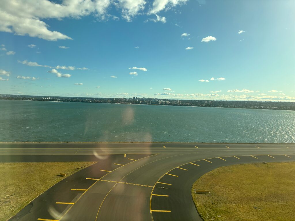 a road with a body of water in the background