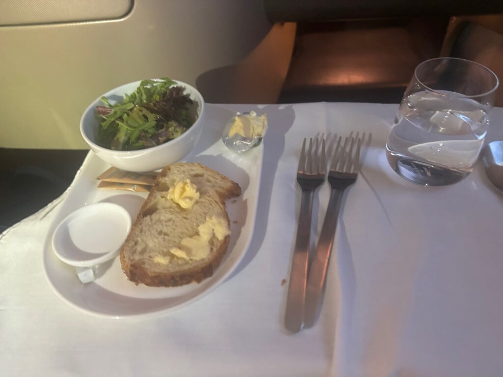 a plate with food and a bowl of salad on it