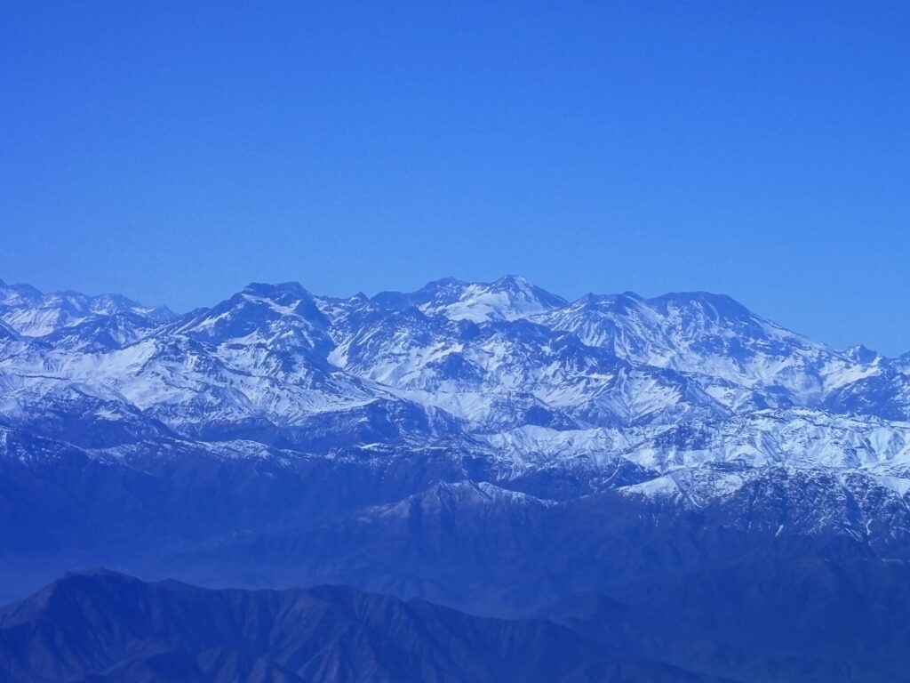 a snowy mountain tops with blue sky