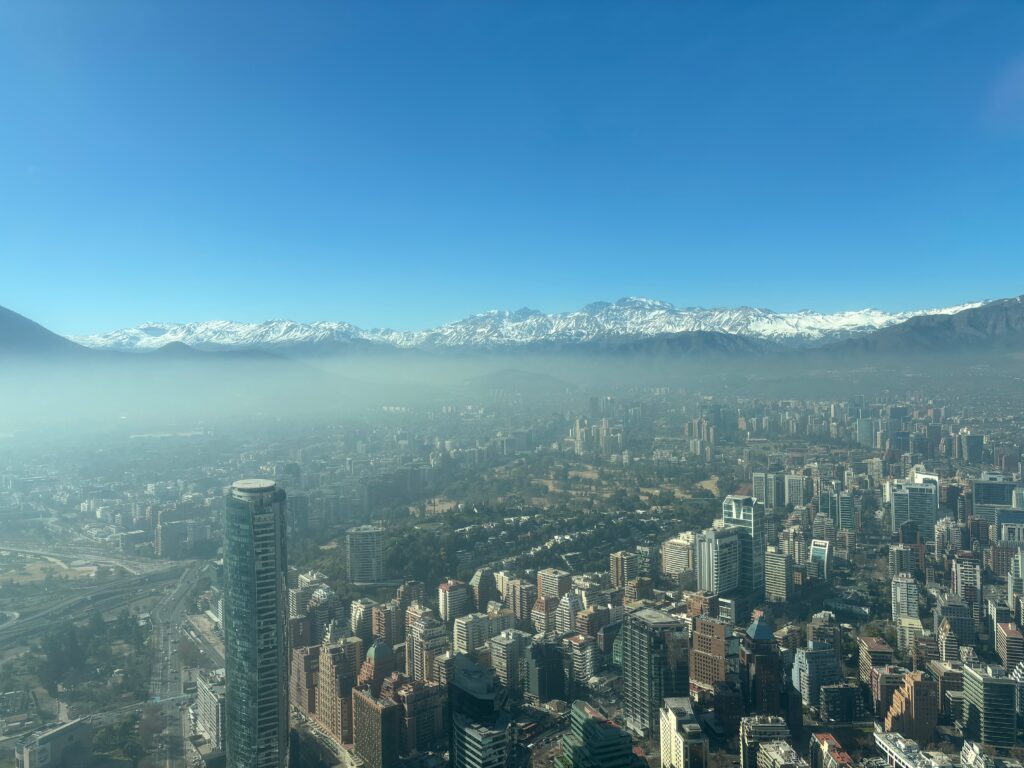 a city with snow covered mountains in the background